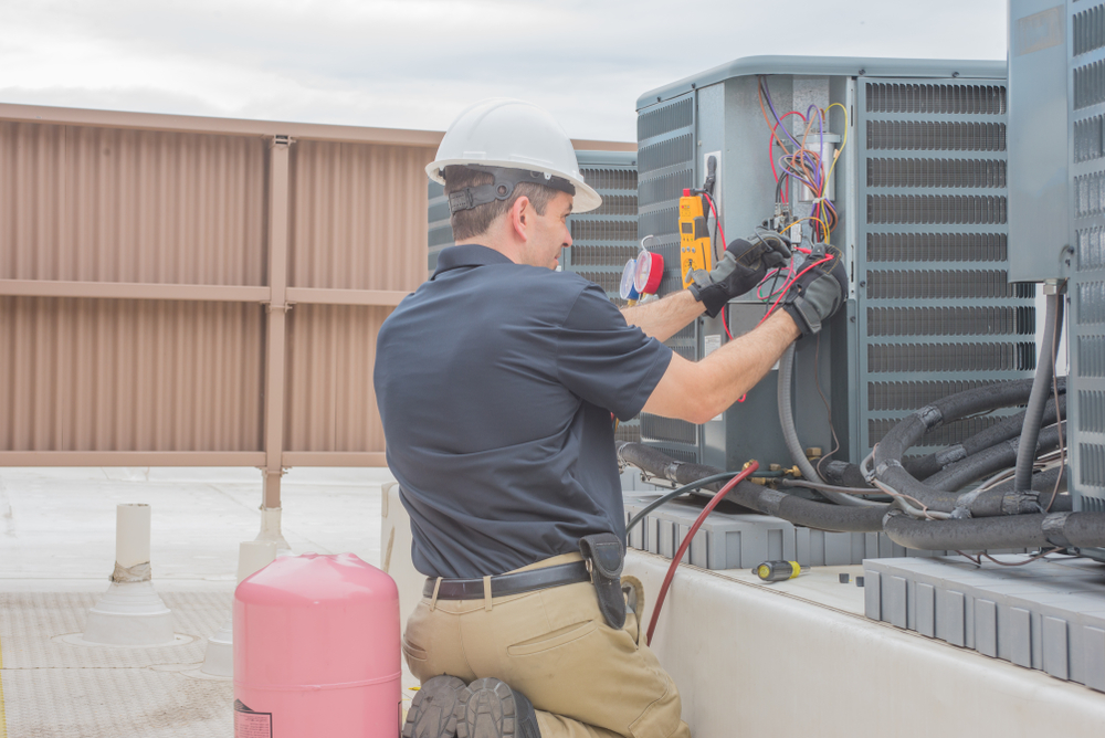 technician installing a commercial HVAC system